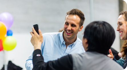 A person showing his mobile to others 