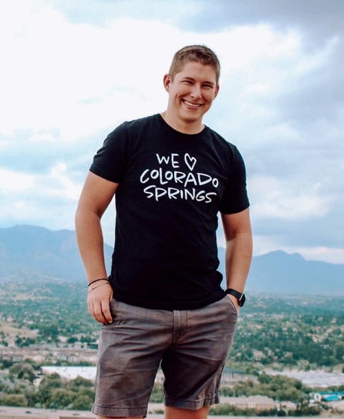Man in black shirt standing
