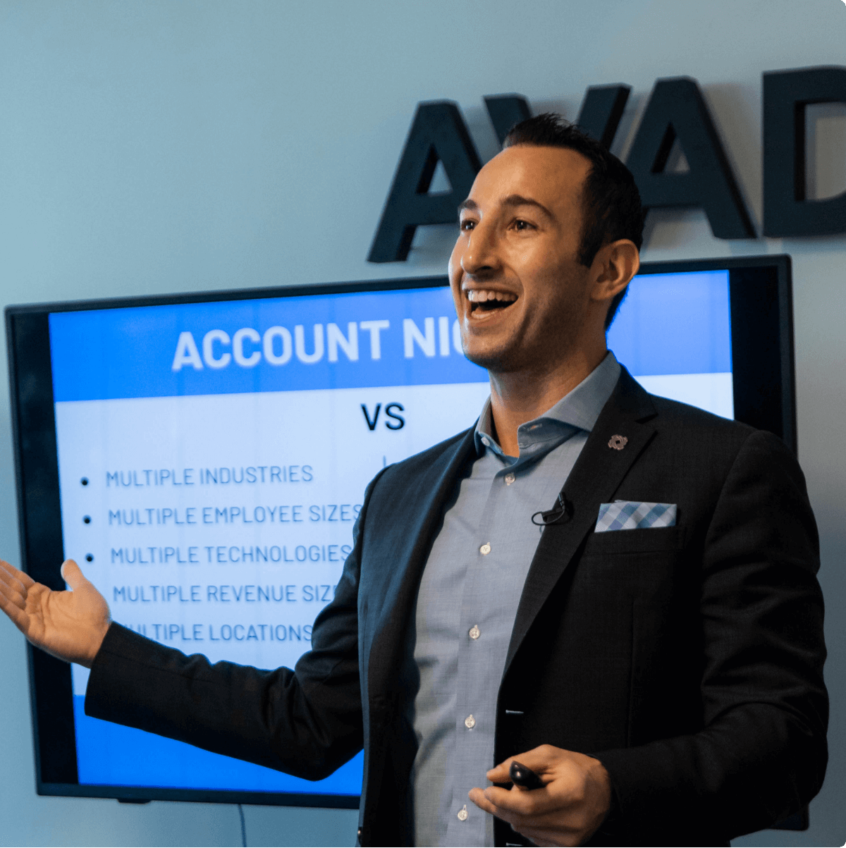 Seamless.AI's founder and C.E.O. Brandon Bornancin talking in a meeting with a presentation behind him