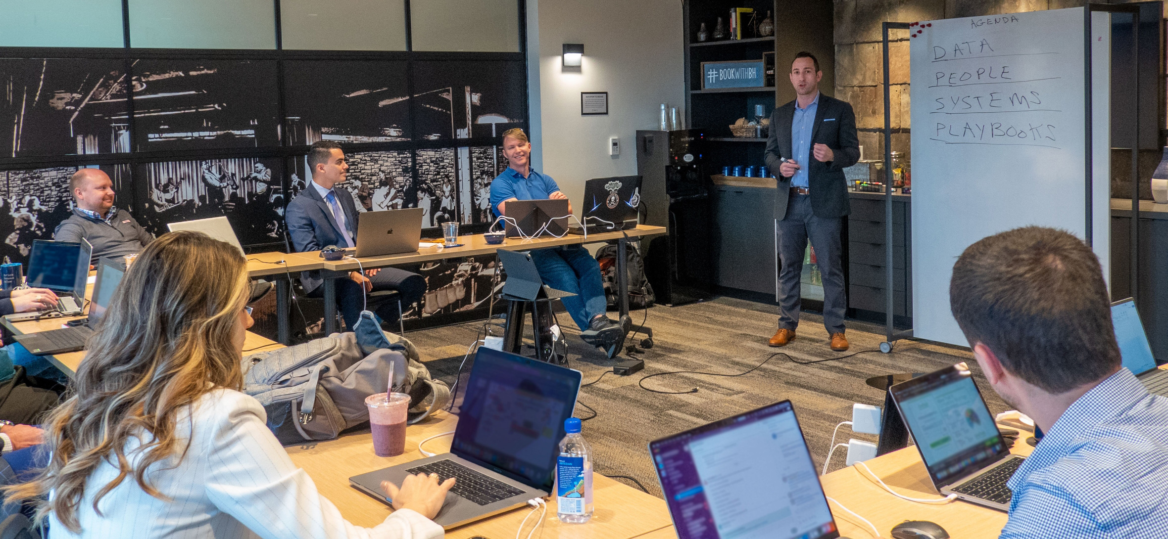 a group of Seamless.AI executives meeting and discussing strategy