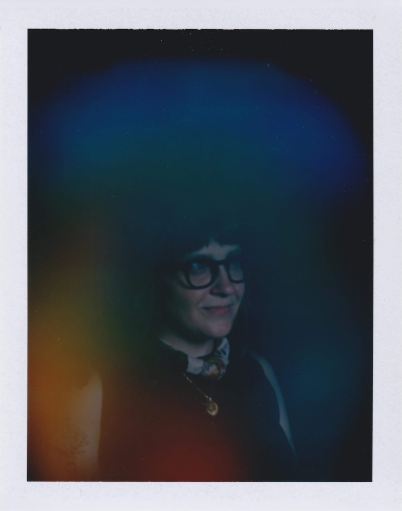 An image of Jes Standefer with her aura layered over top. The blue areas shows her care for others and the orange signifies her analytical thinking.