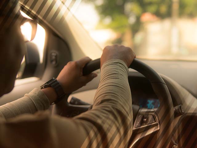 Man driving a used car