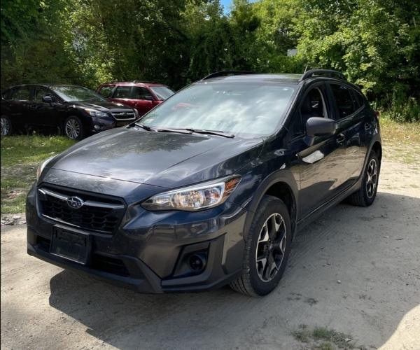 A black Subaru Crosstek in dirt parking lot