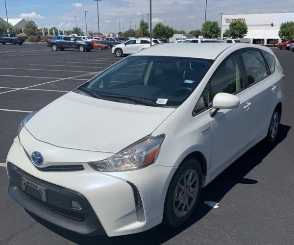 A white Toyota Prius V in a parking lot