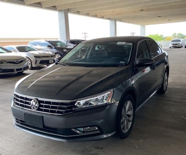 A gray Volkswagen Passat in a covered Parking lot