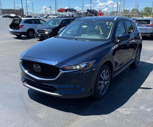 A blue Mazda CX-5 parked in a Dealer Parking Lot