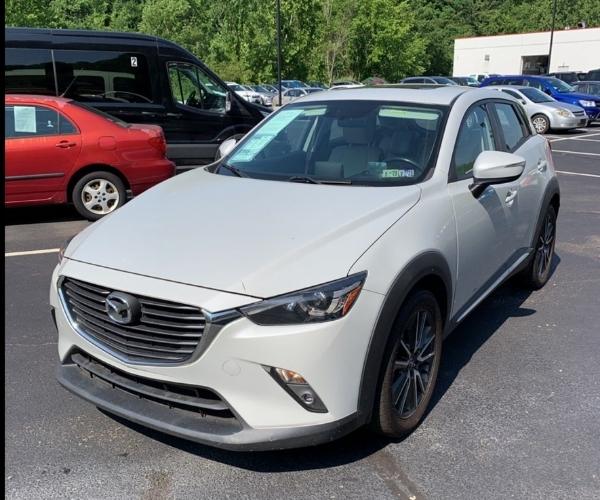 A white Mazda CX-3 in a parking lot