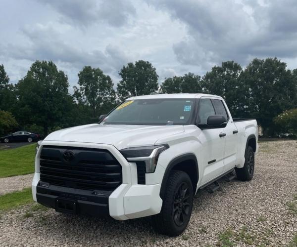 A white 2022 Toyota Tundra in a gravel parking lot
