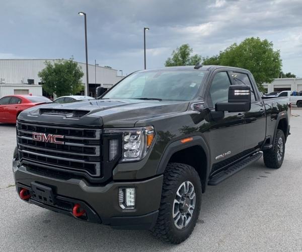 A black 2022 GMC Sierra in a dealership parking lot.