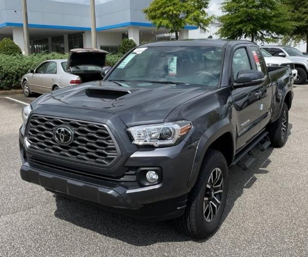 A grey 2022 Toyota Tacoma in a dealership parking lot.