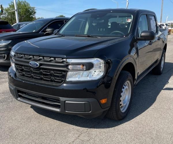 A black 2022 Ford Maverick in a dealership parking lot