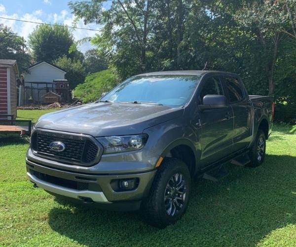 A grey 2022 Ford Ranger in a grassy backyard