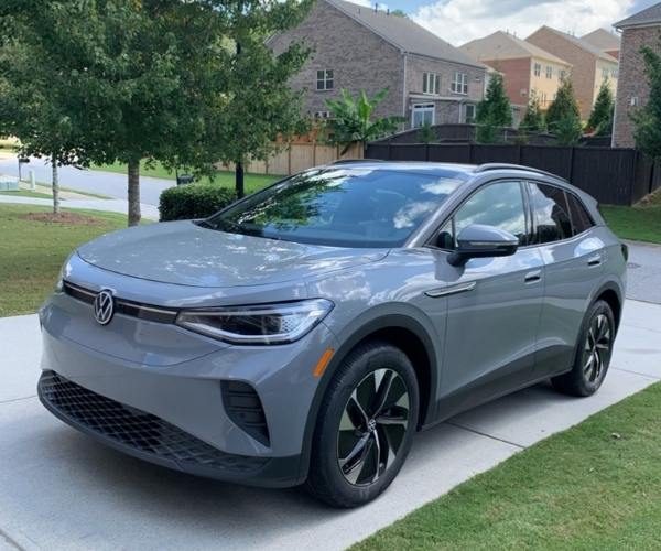 A grey 2022 Volkswagen ID.4 in a neighborhood parking lot