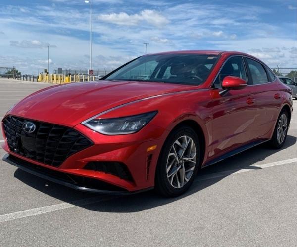 A red 2021 Hyundai Sonata in a empty parking lot