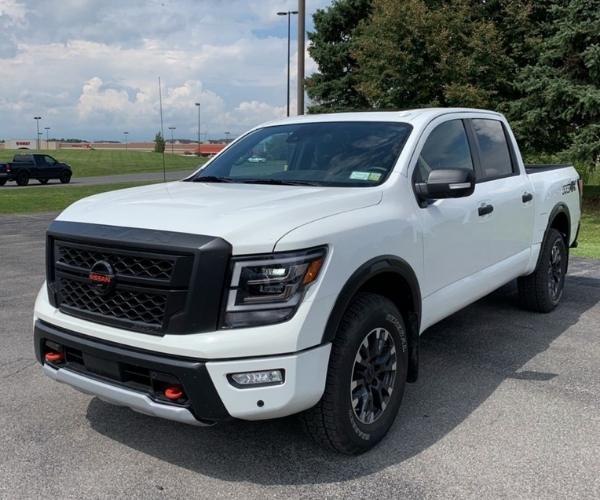 A white 2021 Nissan Titan in a empty parking lot