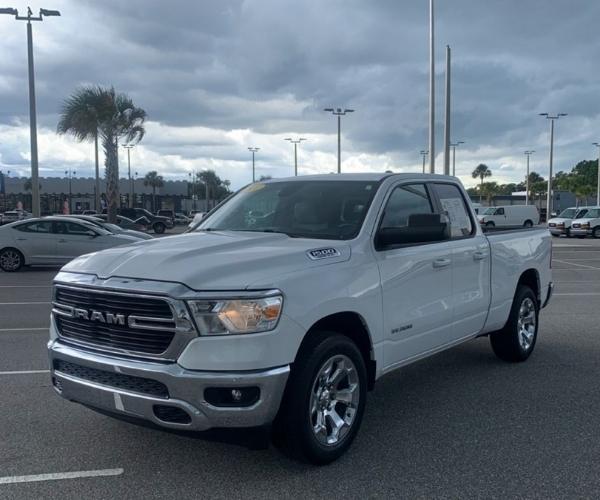 A white 2021 Ram 1500 Truck in a Dealer Parking Lot