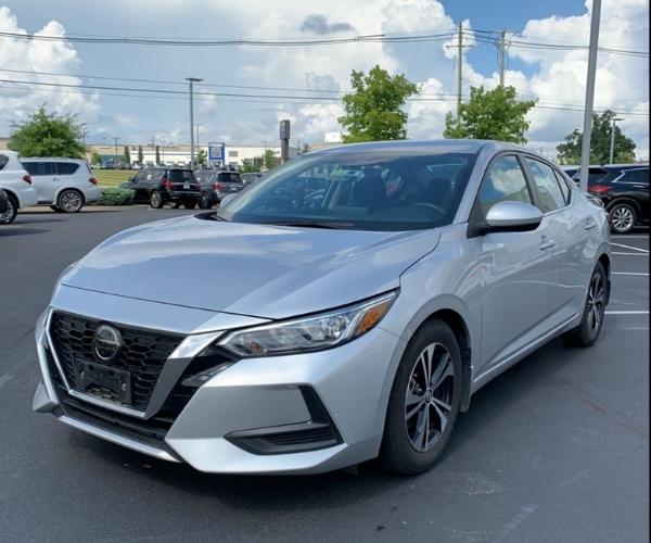 A silver 2021 Nissan Sentra in a dealer parking lot