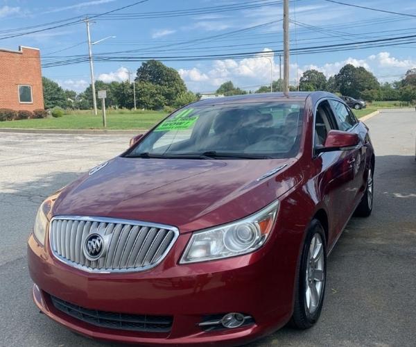 A maroon Buick LaCrosse in an empty parking lot