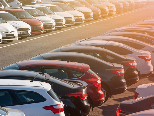 A large group of vehicles in a parking lot