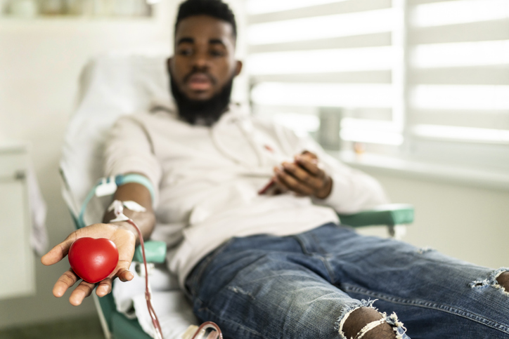 African-American man is happy to donate blood for charity