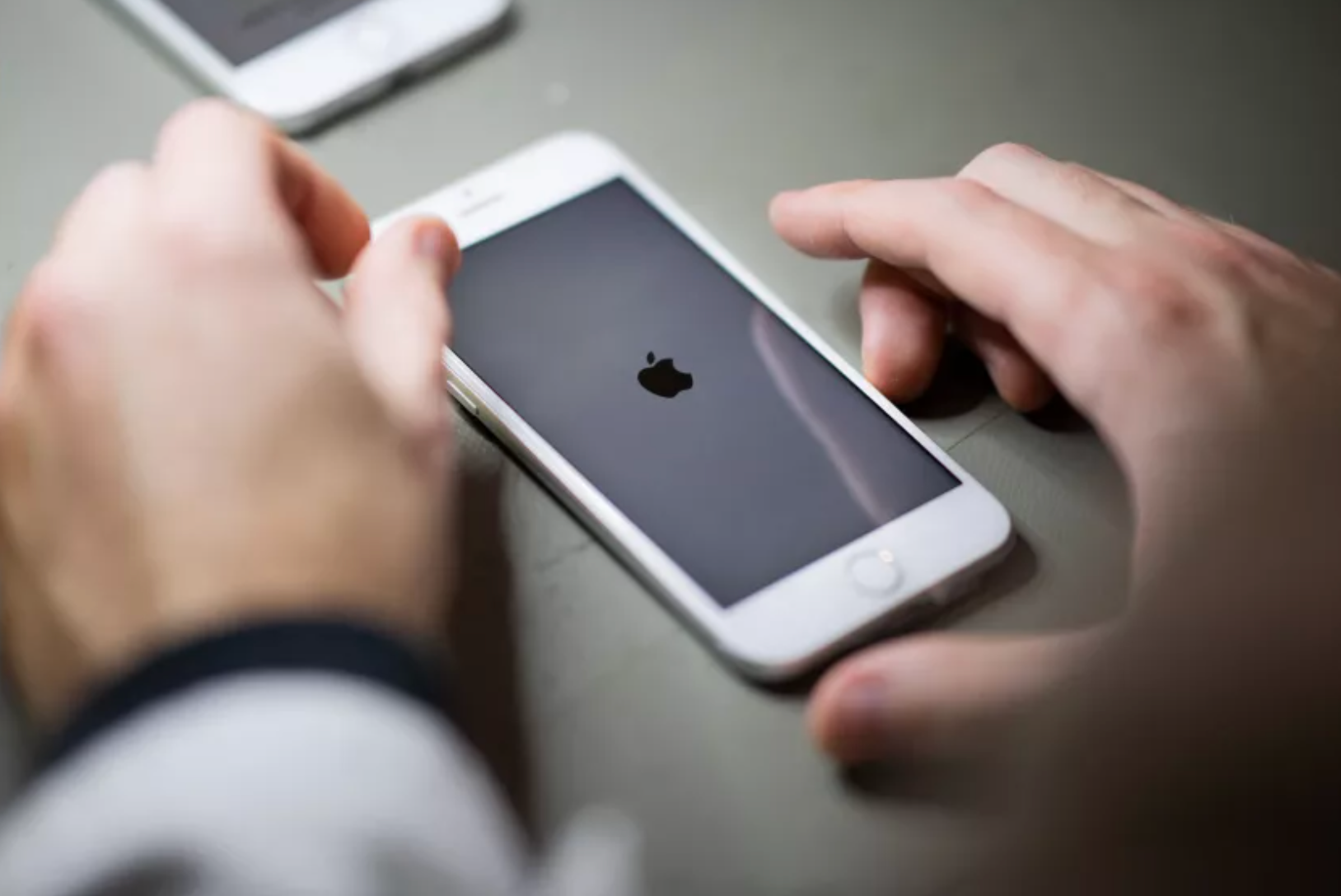 Images of hands with mobile phone on a desk
