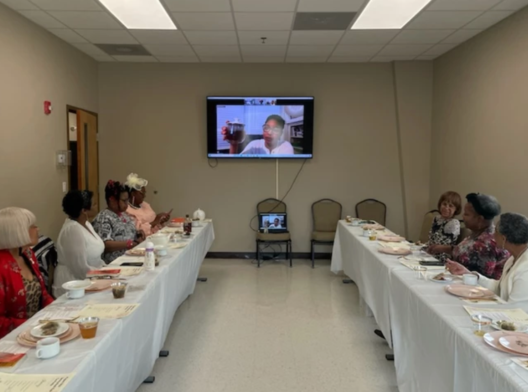 Photograph of women who are part of ProjectTech watching video