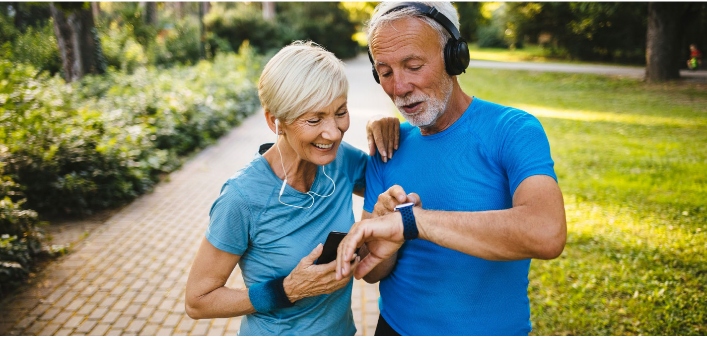 Older couple looking at their smartwatches after exercise