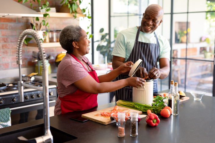 Black couple in their kitchen preparing a healthy meal