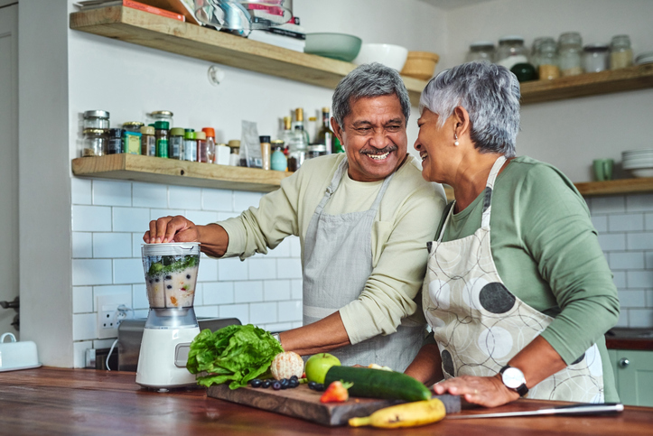 mature couple preparing healthy food in their kitchen