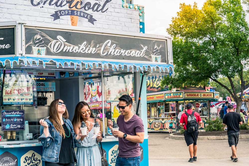 k-days a group of people enjoying ice cream in the midway