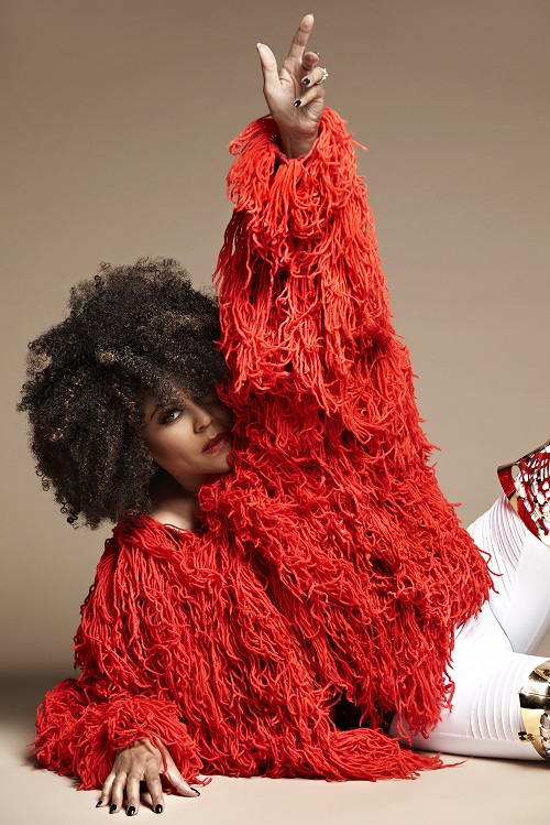 Musician Crystal Waters in a red fringe coat.