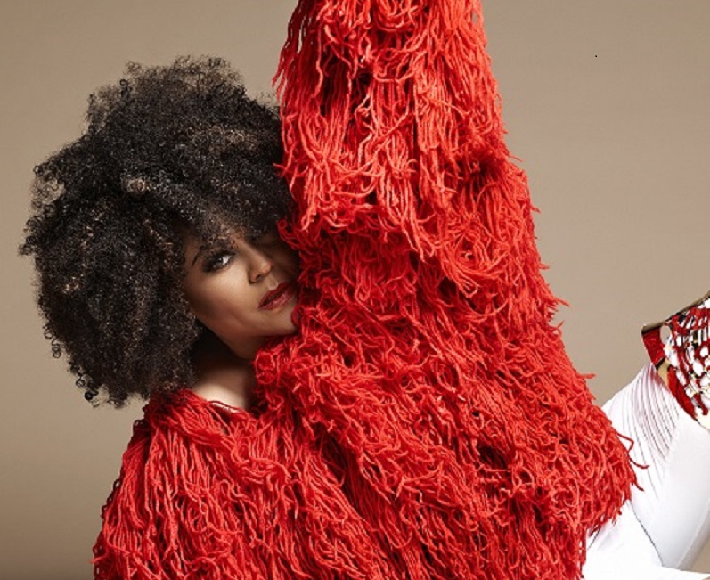 Musician Crystal Waters in a red fringe coat.