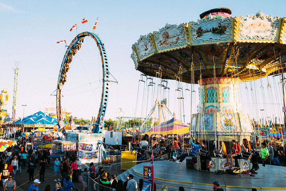 The main fairgrounds of K-Days with a swing ride in the foreground.