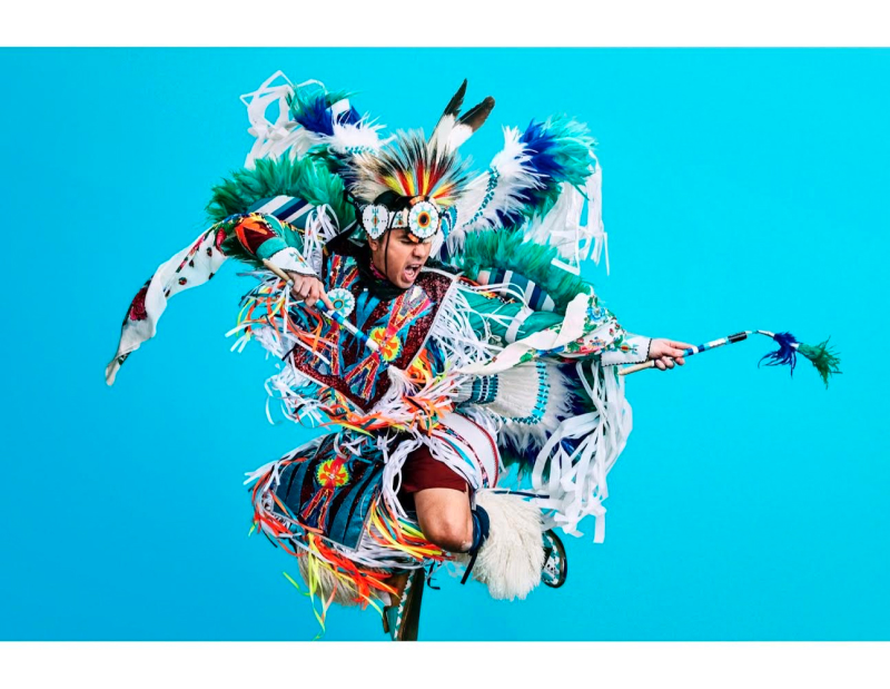 Person in traditional indigenous dress performs a traditional dance