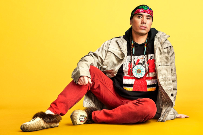 James Jones (Notorious Cree) sits facing the camera with a yellow background