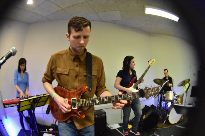 Experience Points band members play instruments in a studio