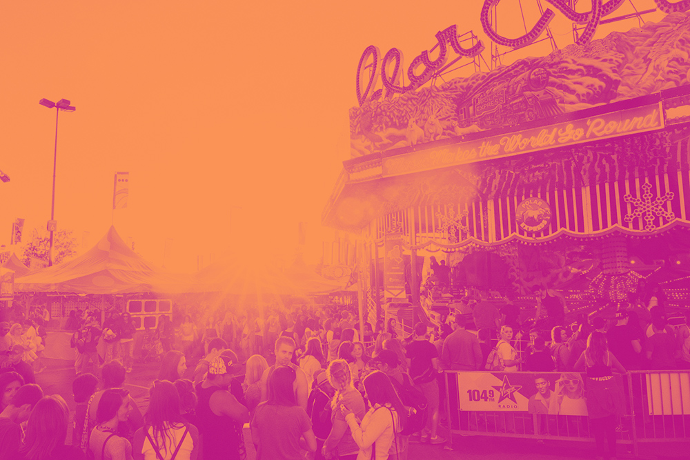 The K-Days midway with an orange and purple filter on the image.