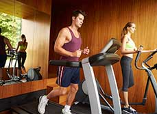 Couple running on a treadmill in a Home Gym