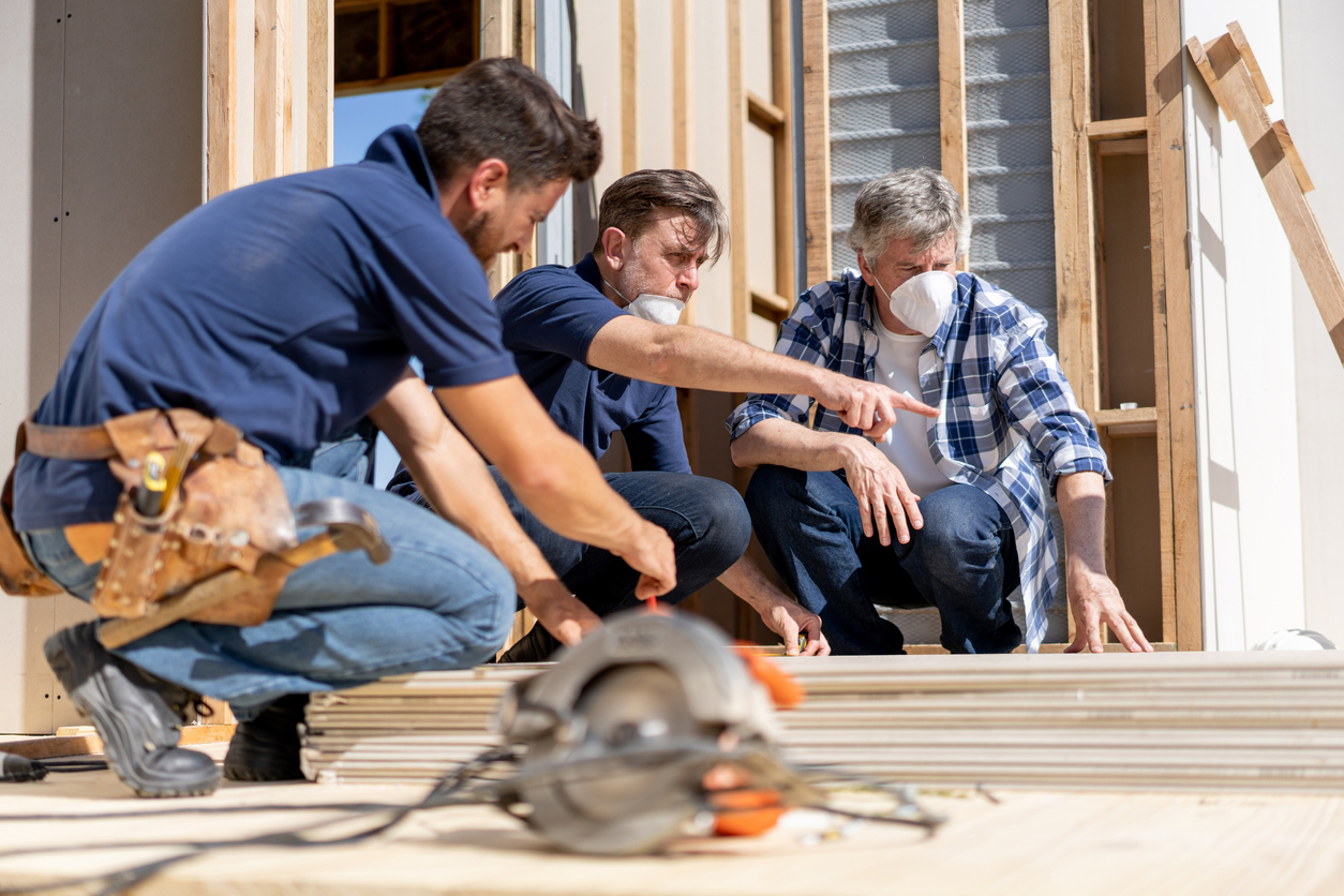 three workers meeting over project on site