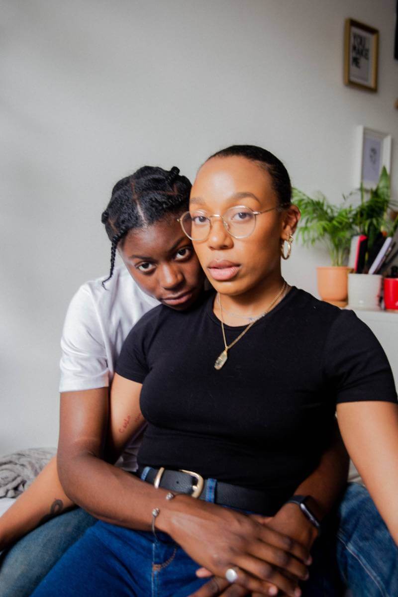 woman hugging woman in black t-shirt