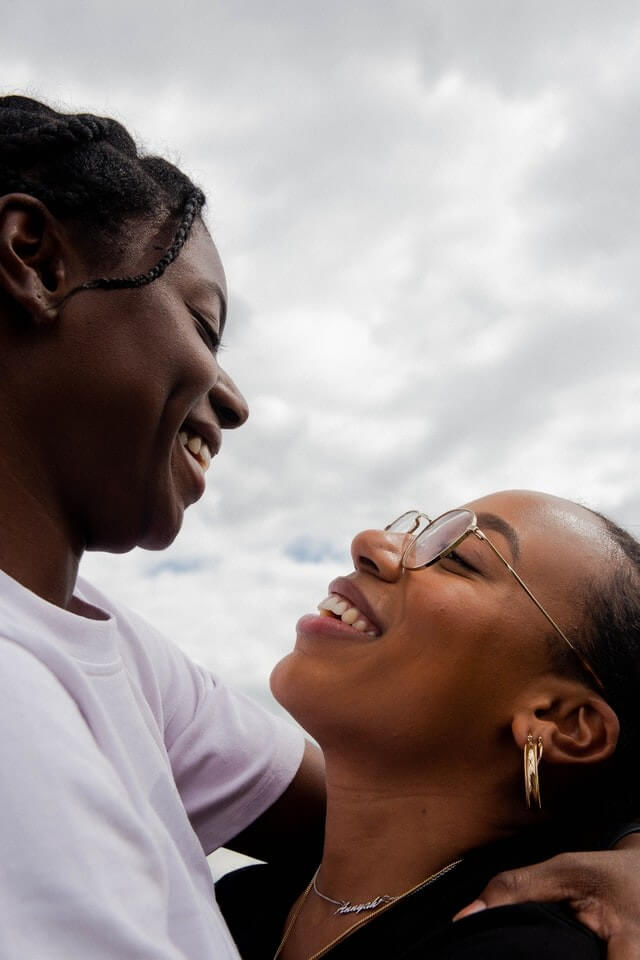 women smiling at each other