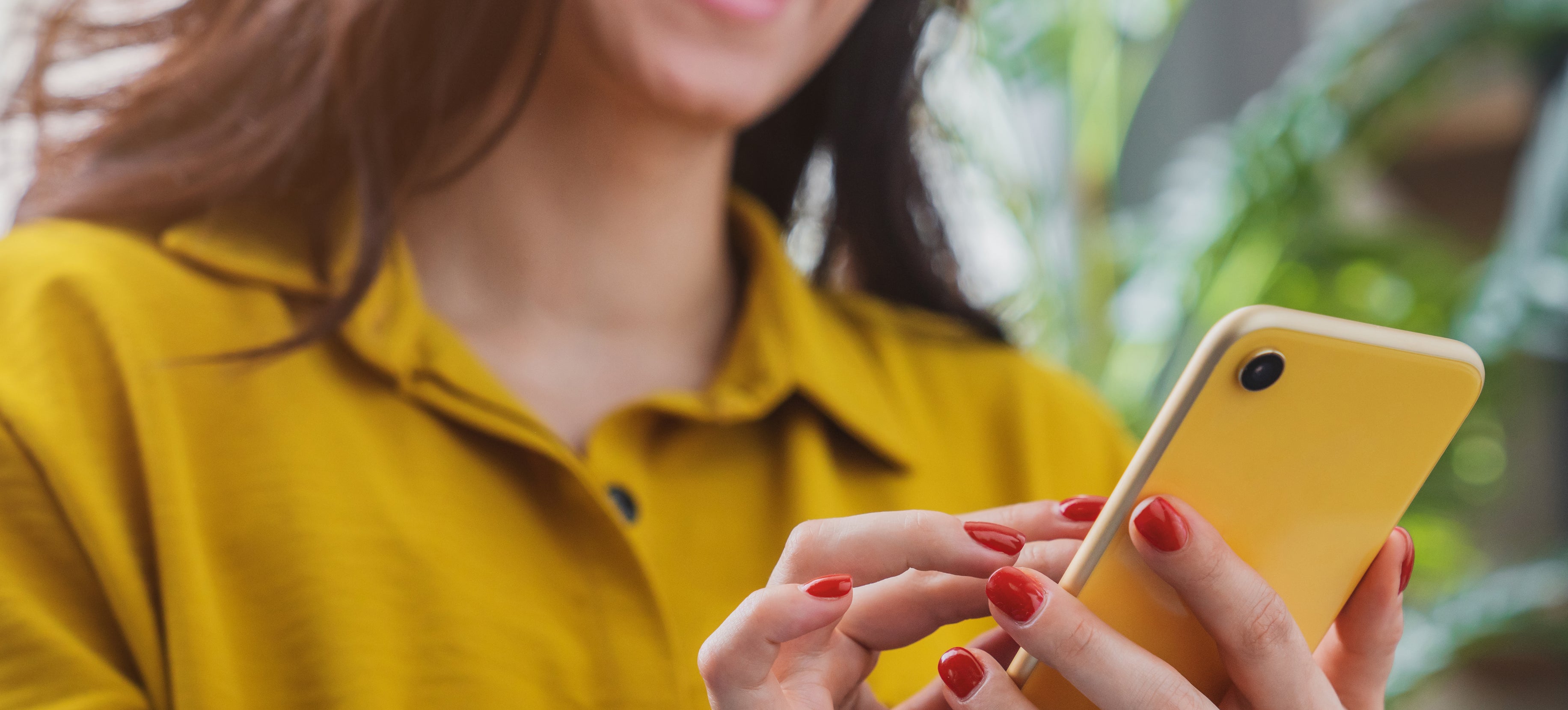 Close up of a woman holding a smart phone.