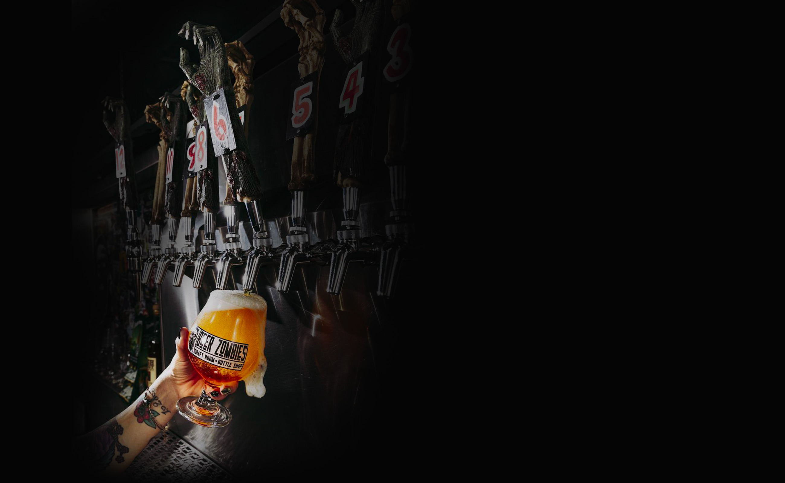 A row of Beer Zombies beer taps with a glass of beer overflowing