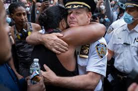 NYPD Officer hugs protester