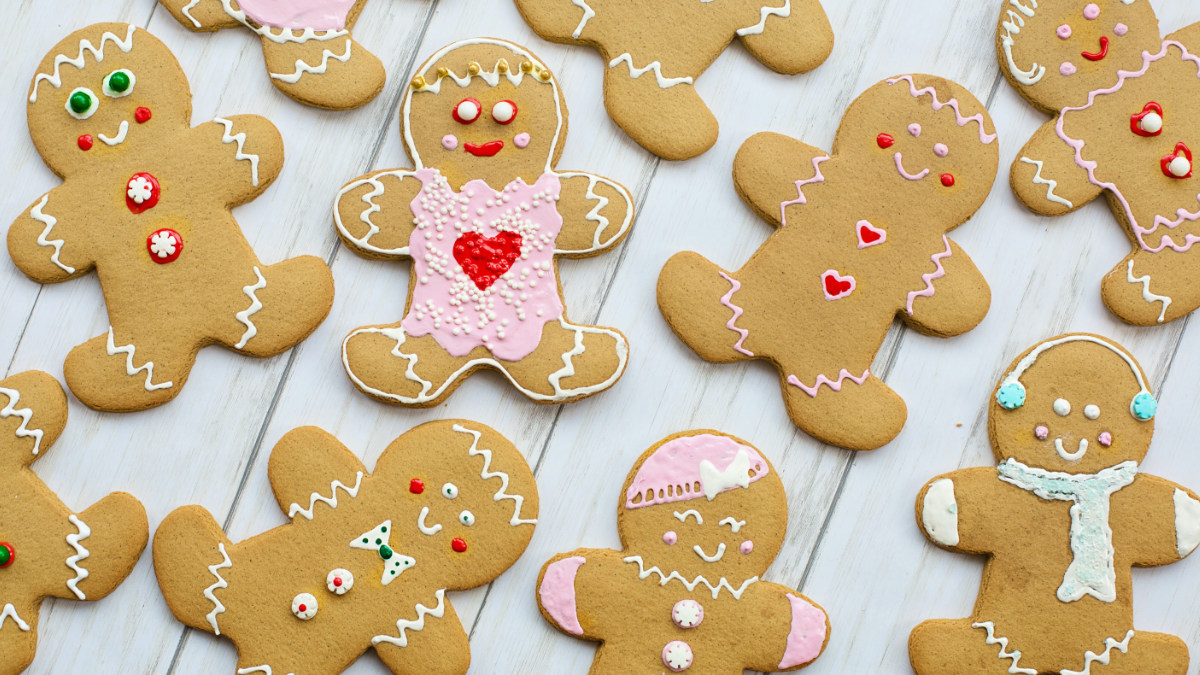 View from above of decorated gingerbread people laid out on a table.