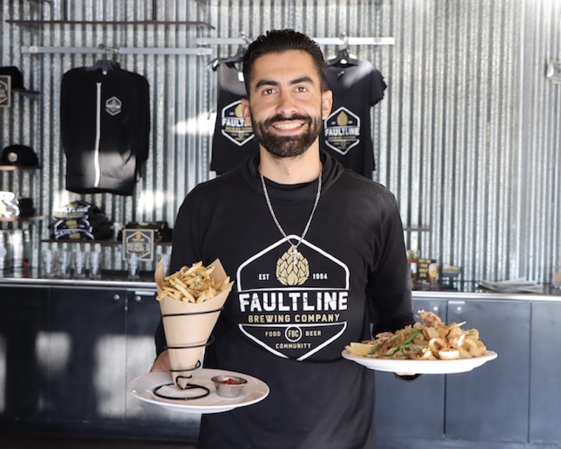 Faultline employee with two plates of food
