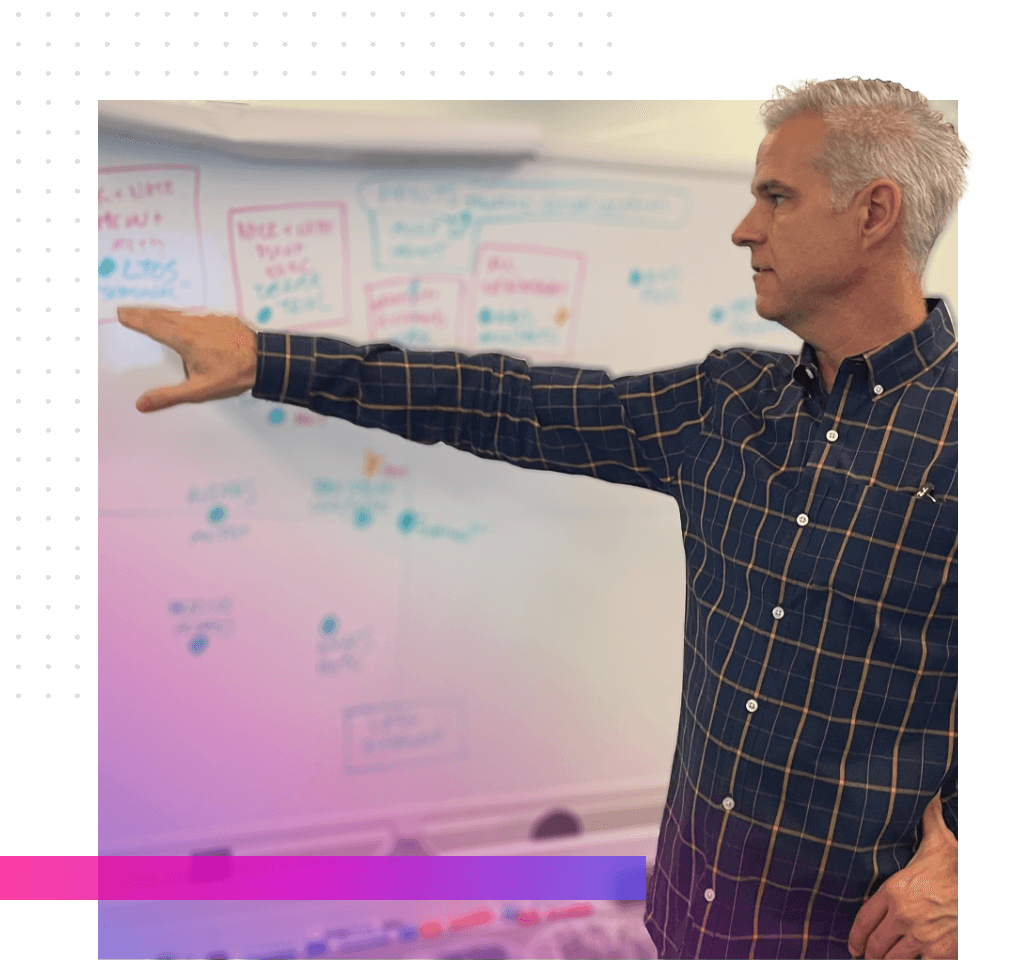 a man explaining his thoughts at a whiteboard