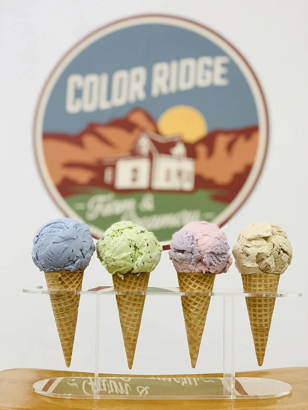 A photo of four ice cream cones with the Color Ridge logo behind them.