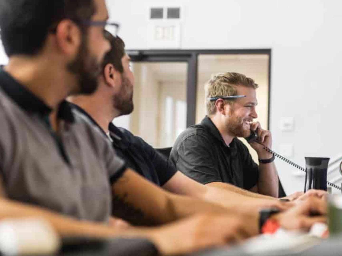 Workers talking on phones and working