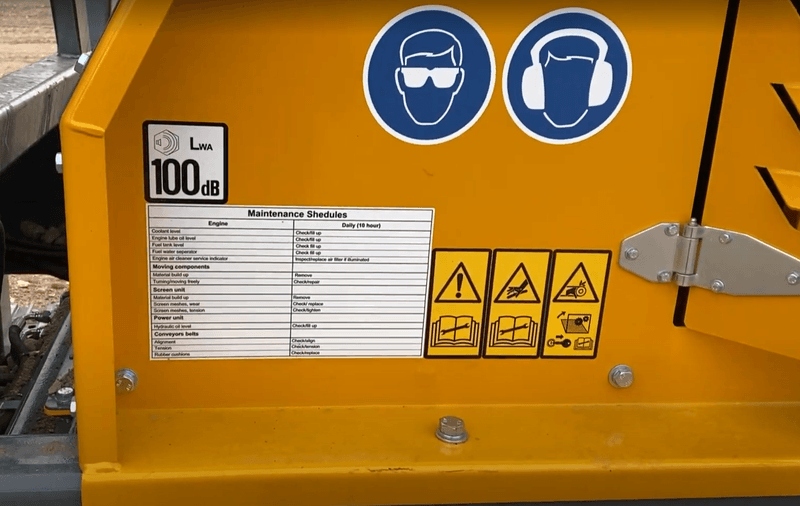 maintenance checklist on the yellow barford sr124 screener along with safety stickers and hazard warnings